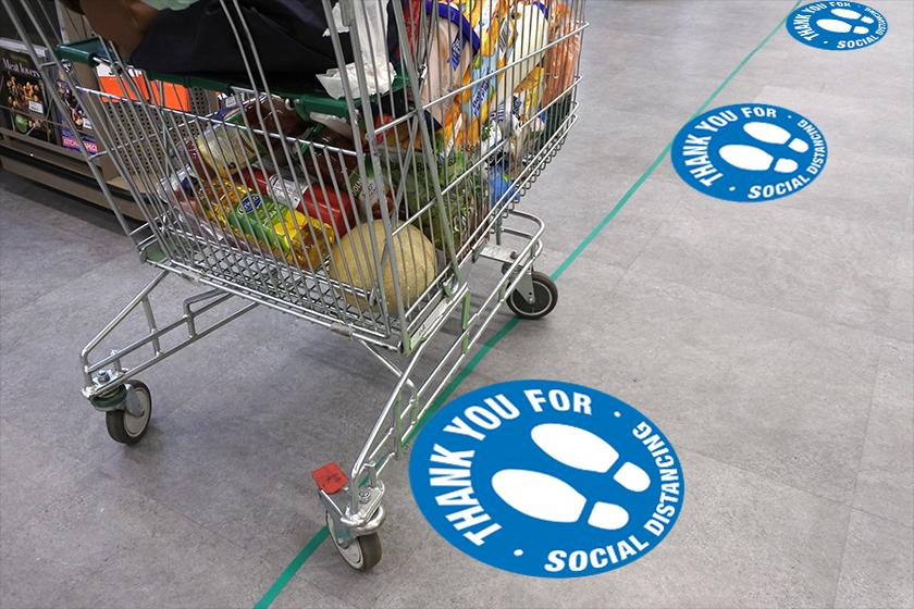 Social distancing floor decals at a grocery store