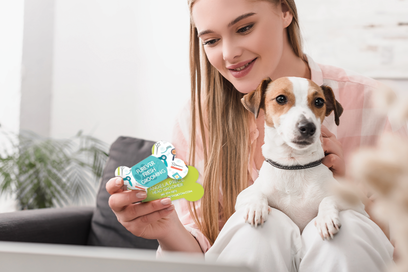 Pet grooming business card in the shape of a bone